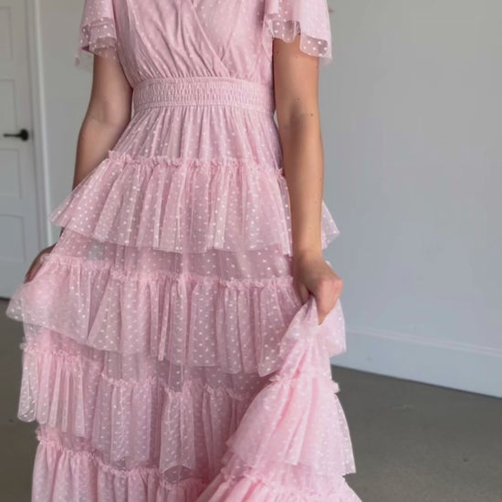 A wrap swiss dot tulle midi dress in blush pink.