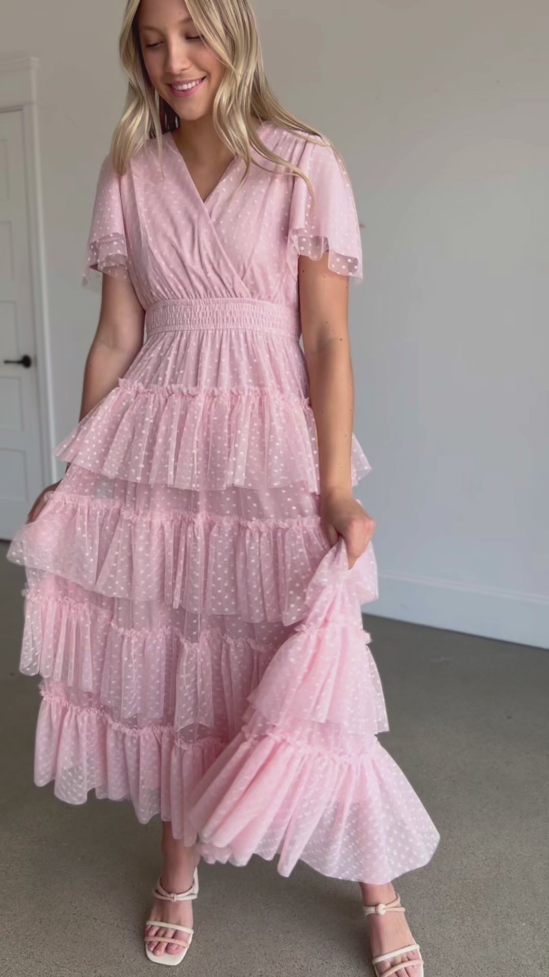 A wrap swiss dot tulle midi dress in blush pink.