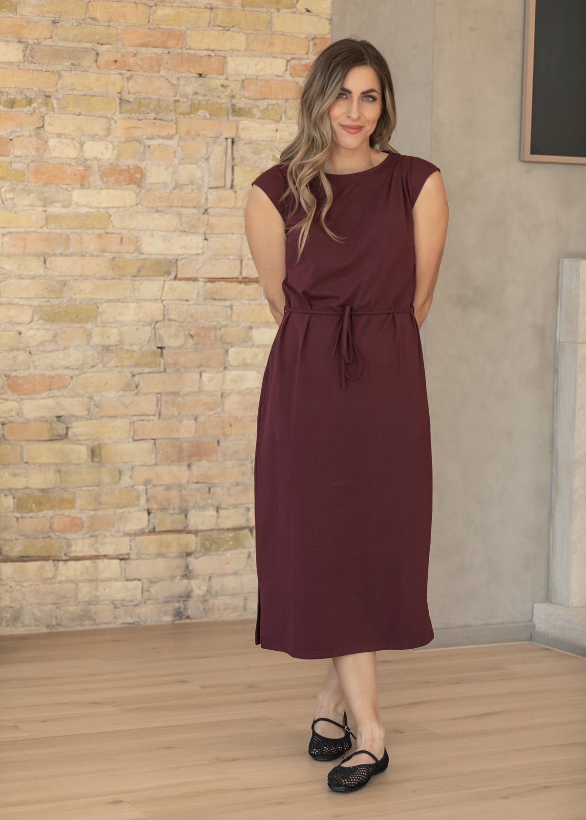 Mulberry self-tie midi dress with cap sleeves and a round neckline, paired with black Mary Jane flats.