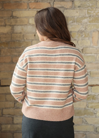Back view of pink, cream, and gray striped knit cardigan