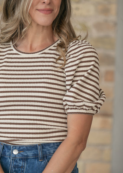 Close-up of brown and cream striped tee tucked into a dark wash denim maxi skirt.