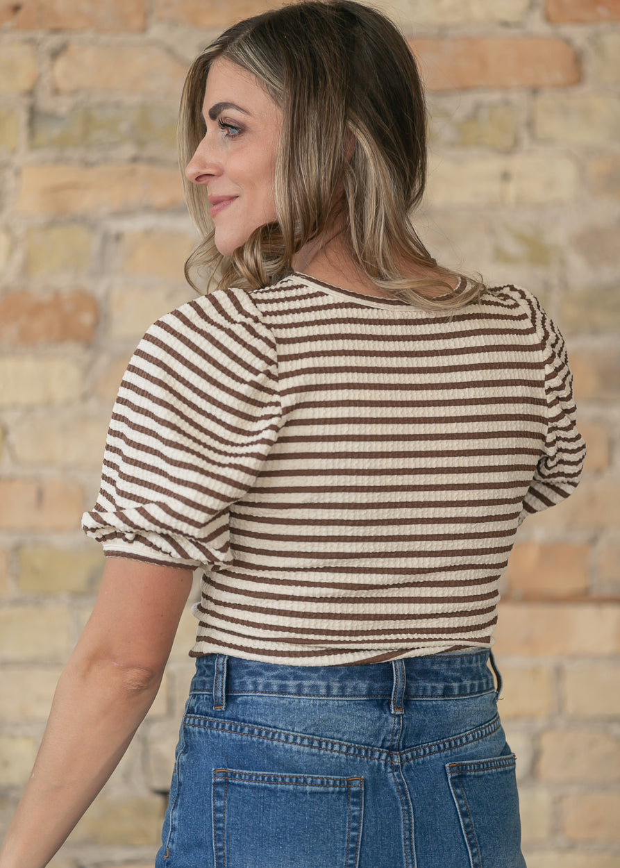 Full-length outfit with brown striped short sleeve tee and dark wash denim maxi skirt.