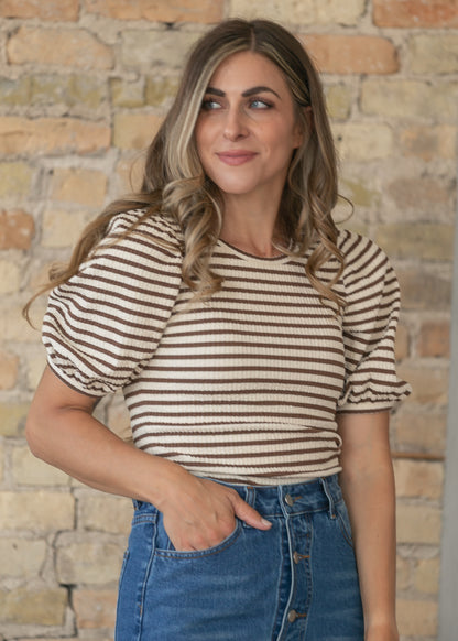 Brown striped short sleeve tee styled with light wash denim for a casual outfit.