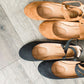 Black or tan ankle wrap faux suede ballet flats.