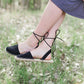 Black ankle wrap sandal with closed-toe and strap back open-heel.