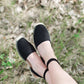 Black ankle wrap sandal with closed-toe and strap back open-heel.