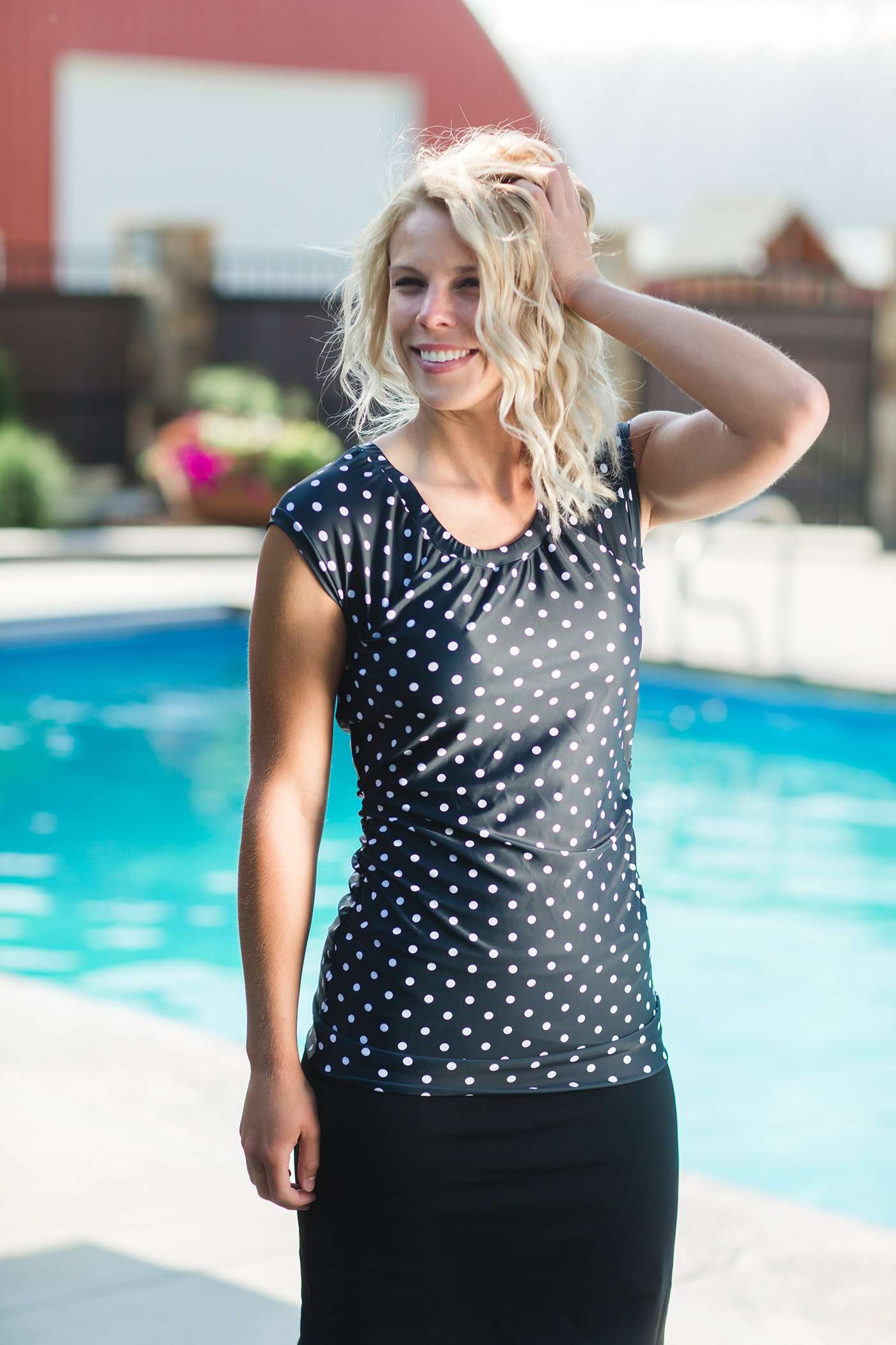 Women's modest cap sleeve swim suit top, black with white polka dots.