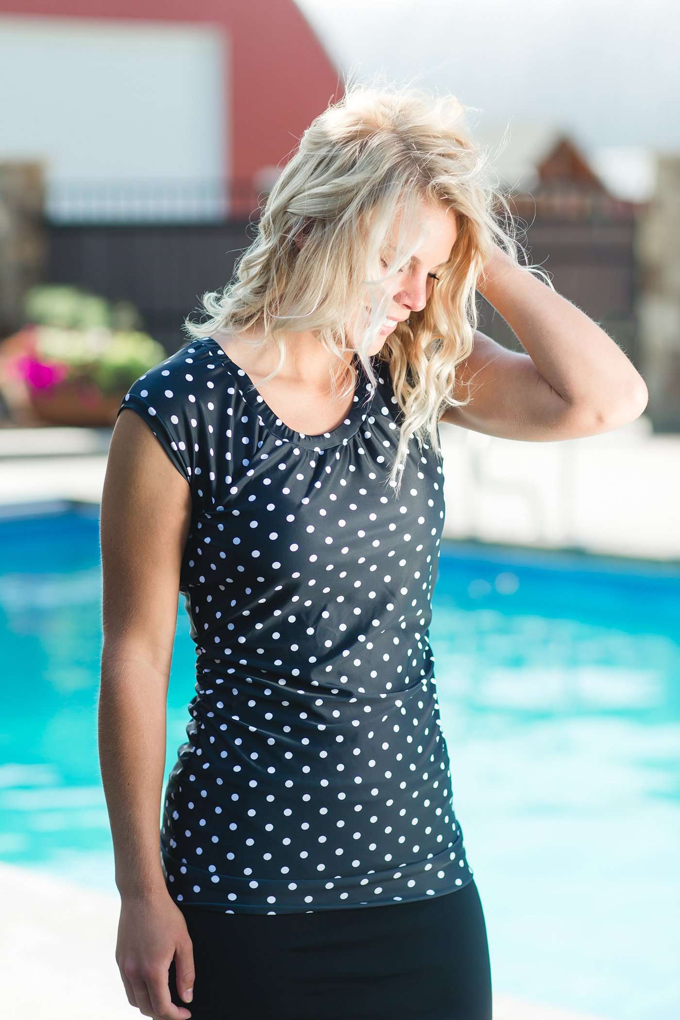 Women's modest cap sleeve swim suit top, black with white polka dots.
