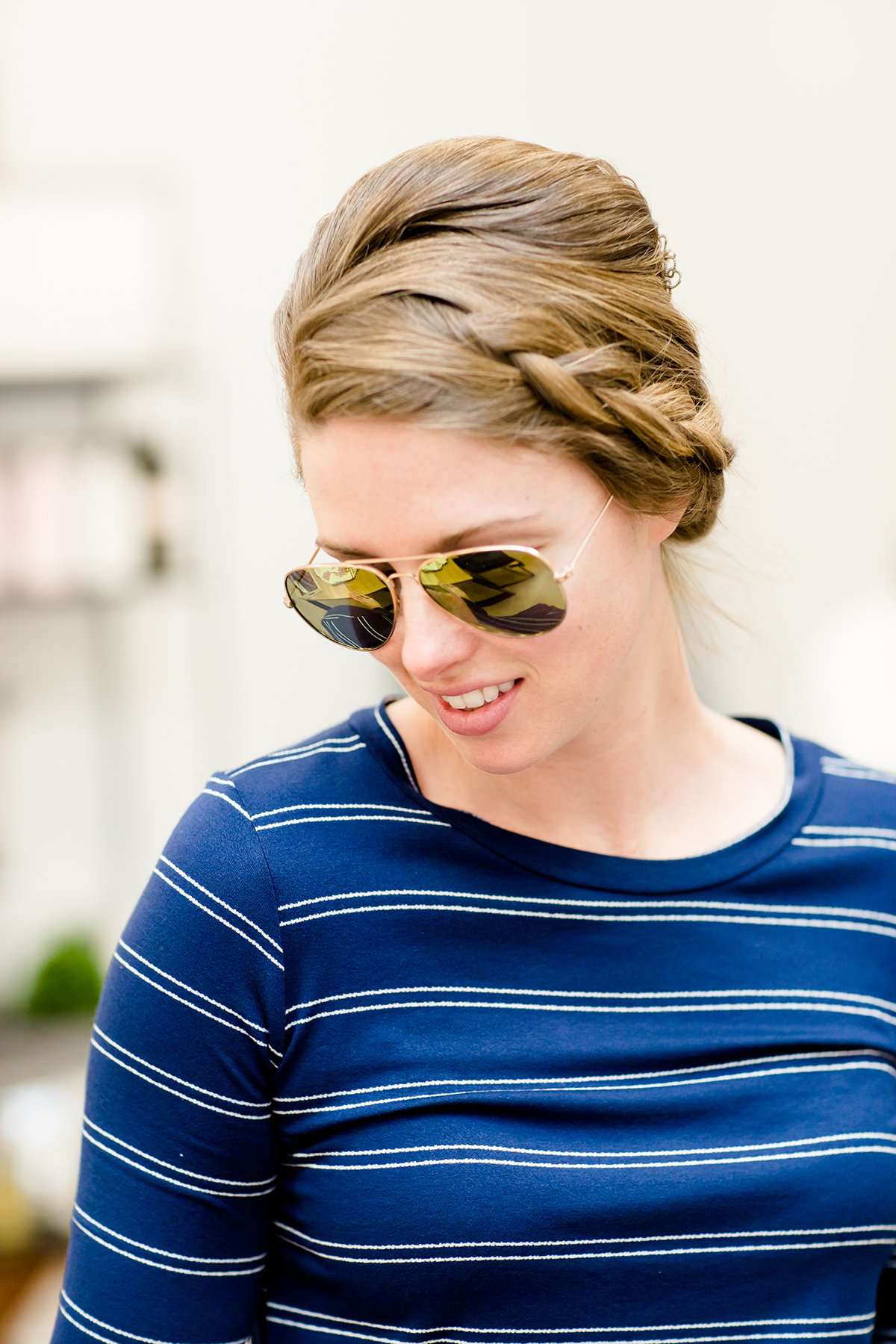 woman wearing aviator style sunglasses in rose gold