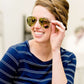 woman wearing aviator style sunglasses in rose gold