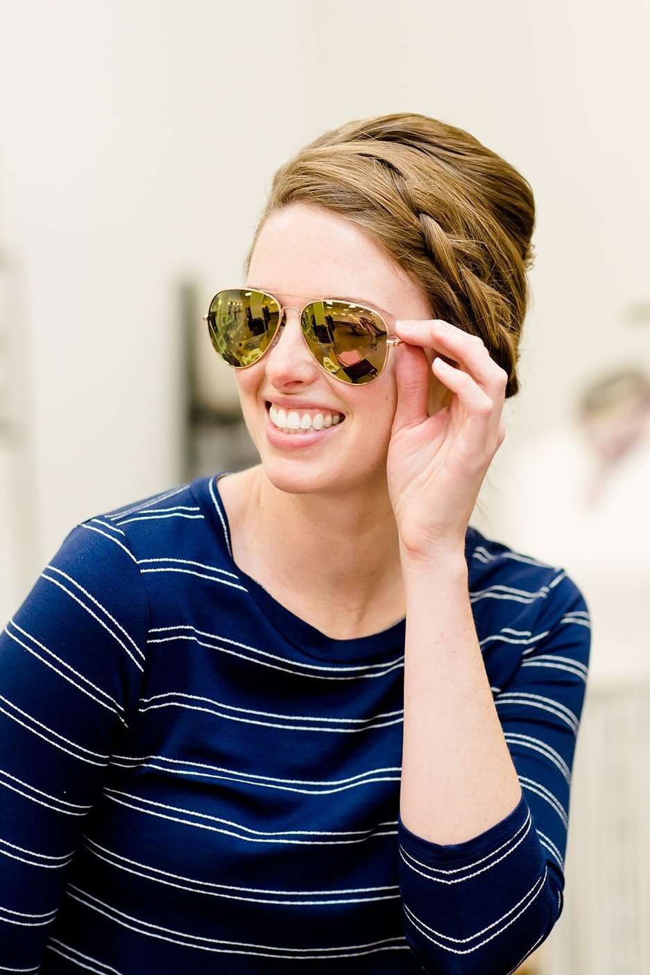woman wearing aviator style sunglasses in rose gold