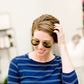 woman wearing aviator style sunglasses in rose gold