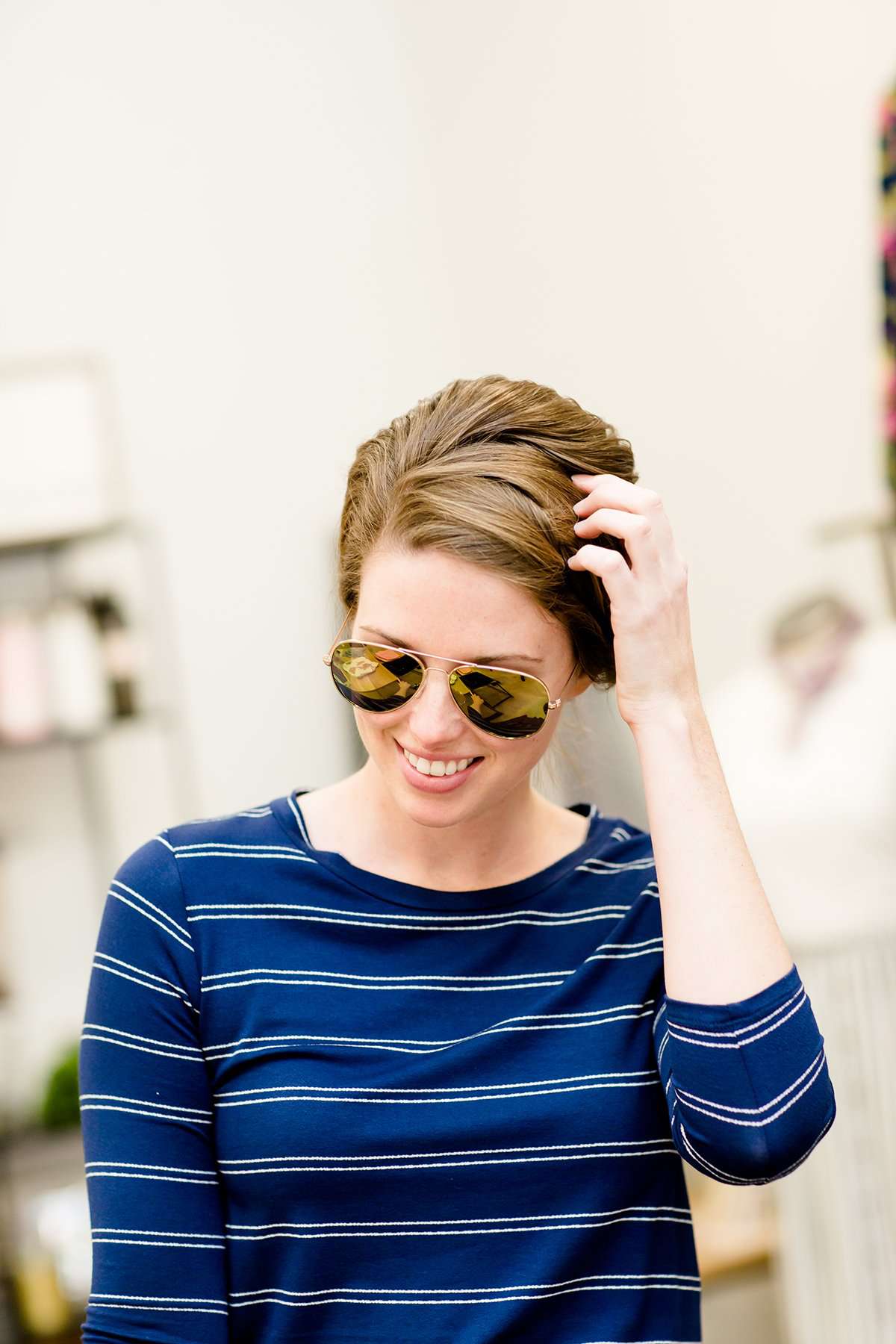 woman wearing aviator style sunglasses in rose gold