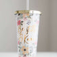 Be still and know double wall tumbler. This tumbler has flowers adorning it and accented with a gold cap and gold writing.