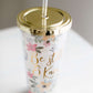 Be still and know double wall tumbler. This tumbler has flowers adorning it and accented with a gold cap and gold writing.