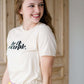 be the example cream colored graphic tee