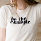 be the example cream colored graphic tee
