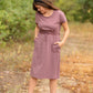 This is a Cinch Waist Athletic midi dress in a purpley taupe color that has a mesh detail and large side pockets. 