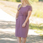 This is a Cinch Waist Athletic midi dress in a purpley taupe color that has a mesh detail and large side pockets. 
