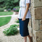 Modest white belle-sleeve top with Earthy colored embroidery down the front.