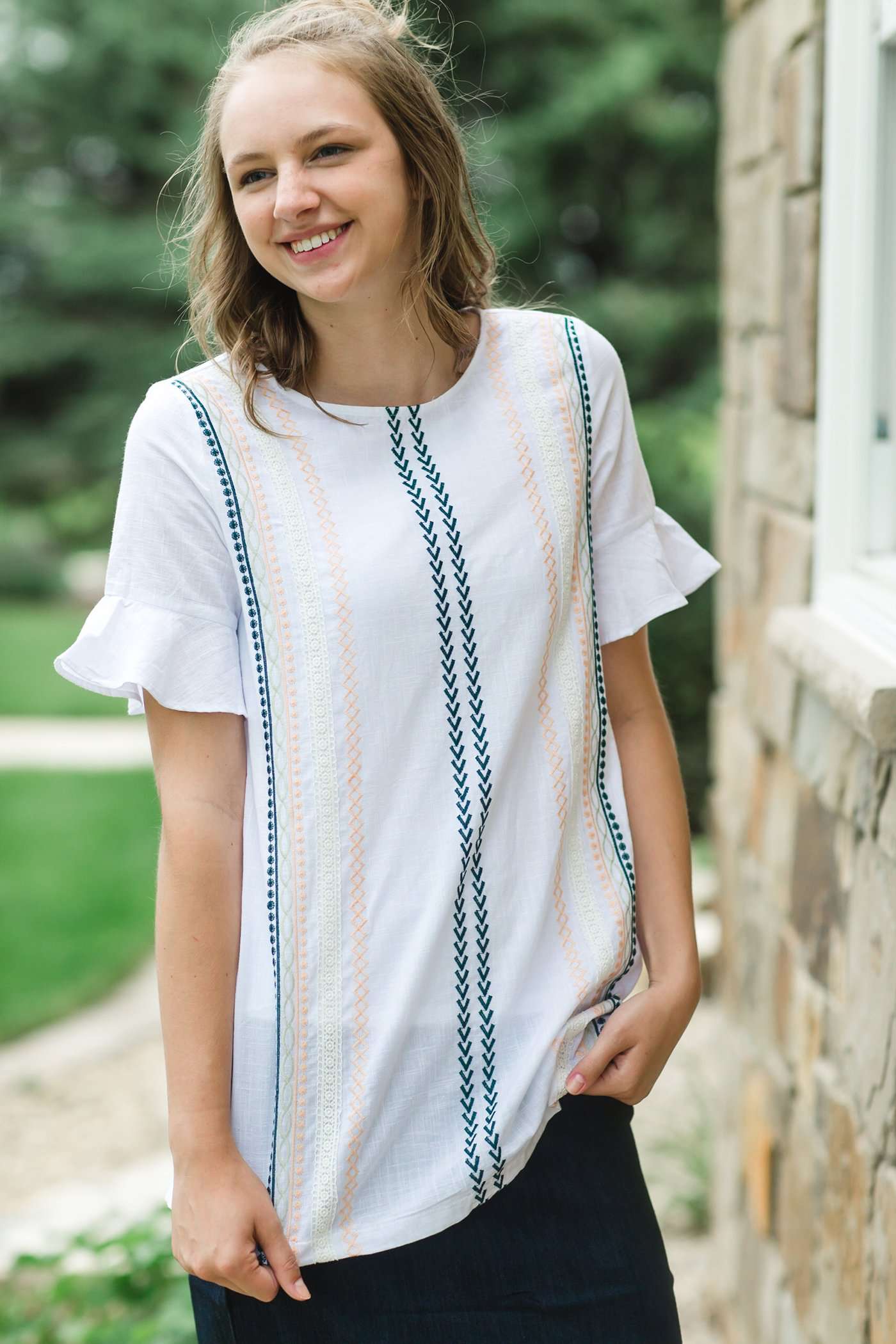 Modest white belle-sleeve top with Earthy colored embroidery down the front. 