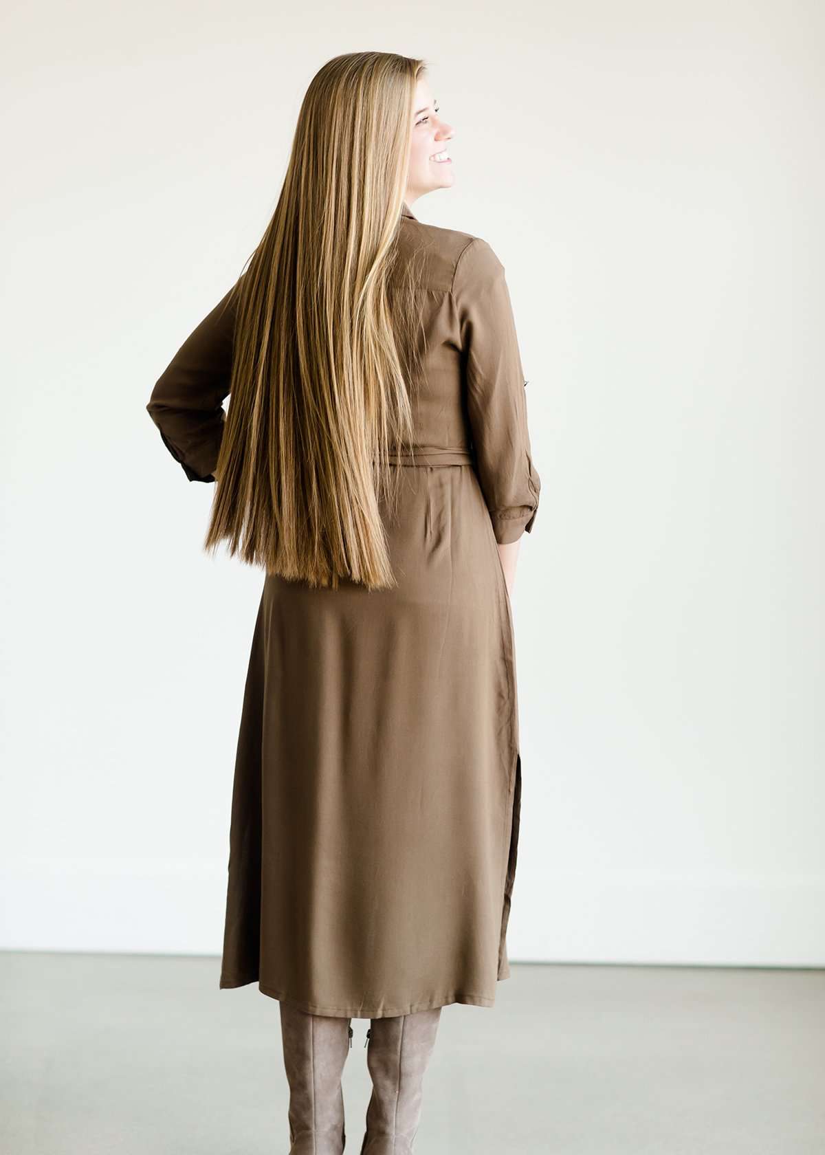 Olive colored belted midi dress with buttons running down the front.