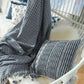 Hand-woven gray and white Bloom and Give throw blanket.