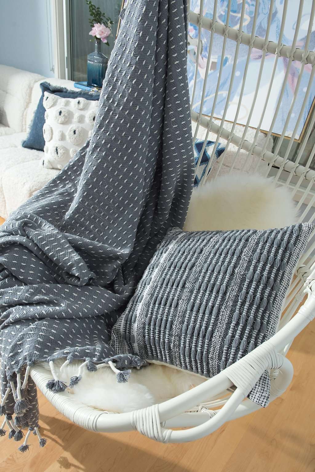 Hand-woven gray and white Bloom and Give throw blanket.