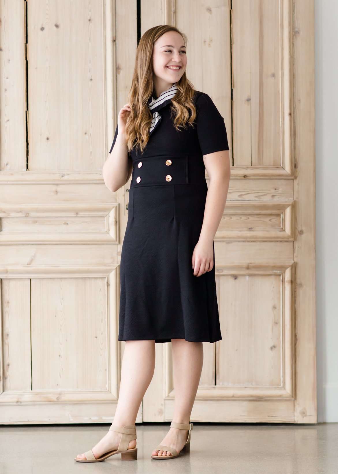 modest black midi dress with gold button accent
