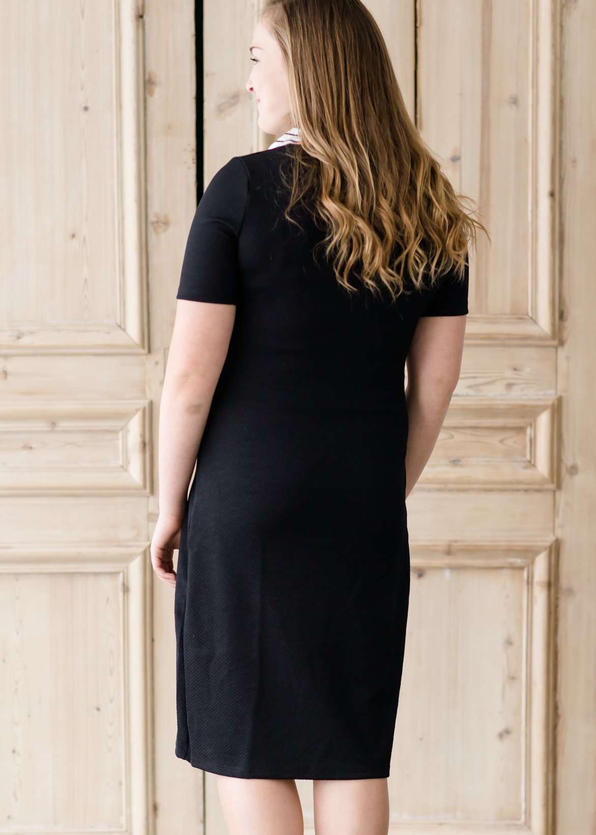 modest black midi dress with gold button accent