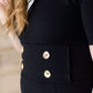 modest black midi dress with gold button accent
