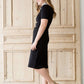 modest black midi dress with gold button accent