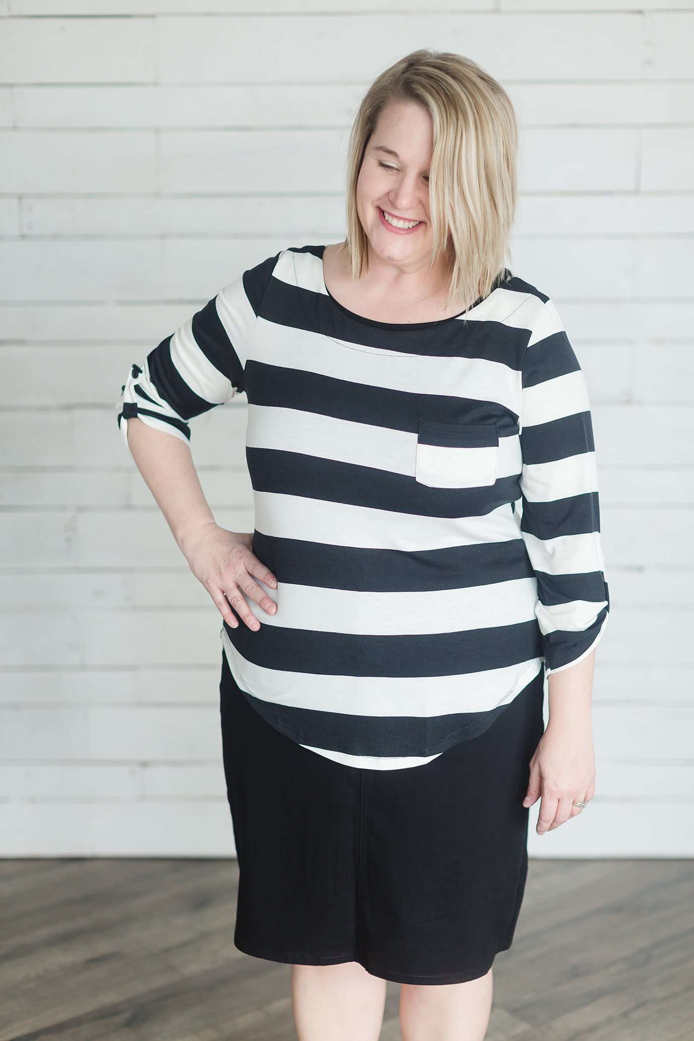 Modest black and white stripe, three quarter length sleeve with front pocket.
