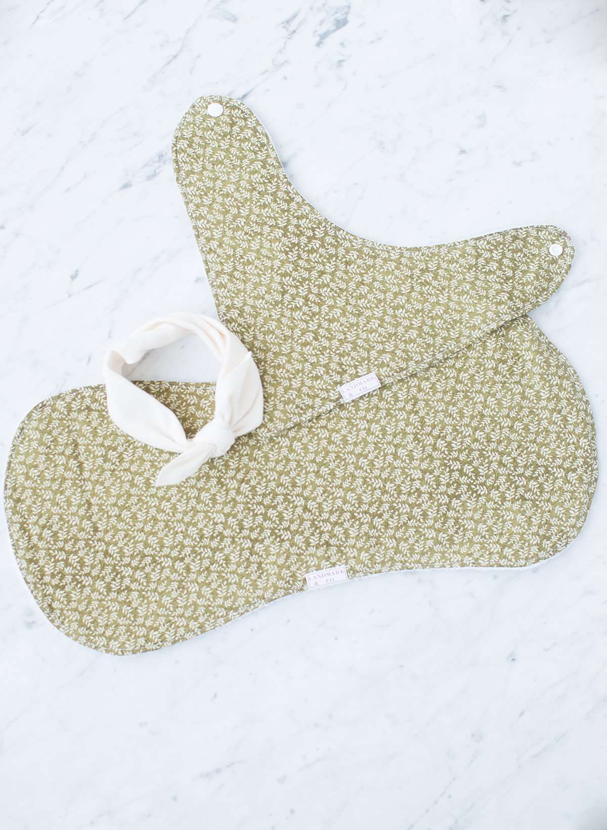 This is a sage colored baby burp cloth, baby bandana and headband gift set.