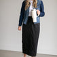 A black midi skirt with a drawstring waist, ribbed hem, pockets, and bottom side zipper.