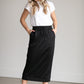 A black midi skirt with a drawstring waist, ribbed hem, pockets, and bottom side zipper.