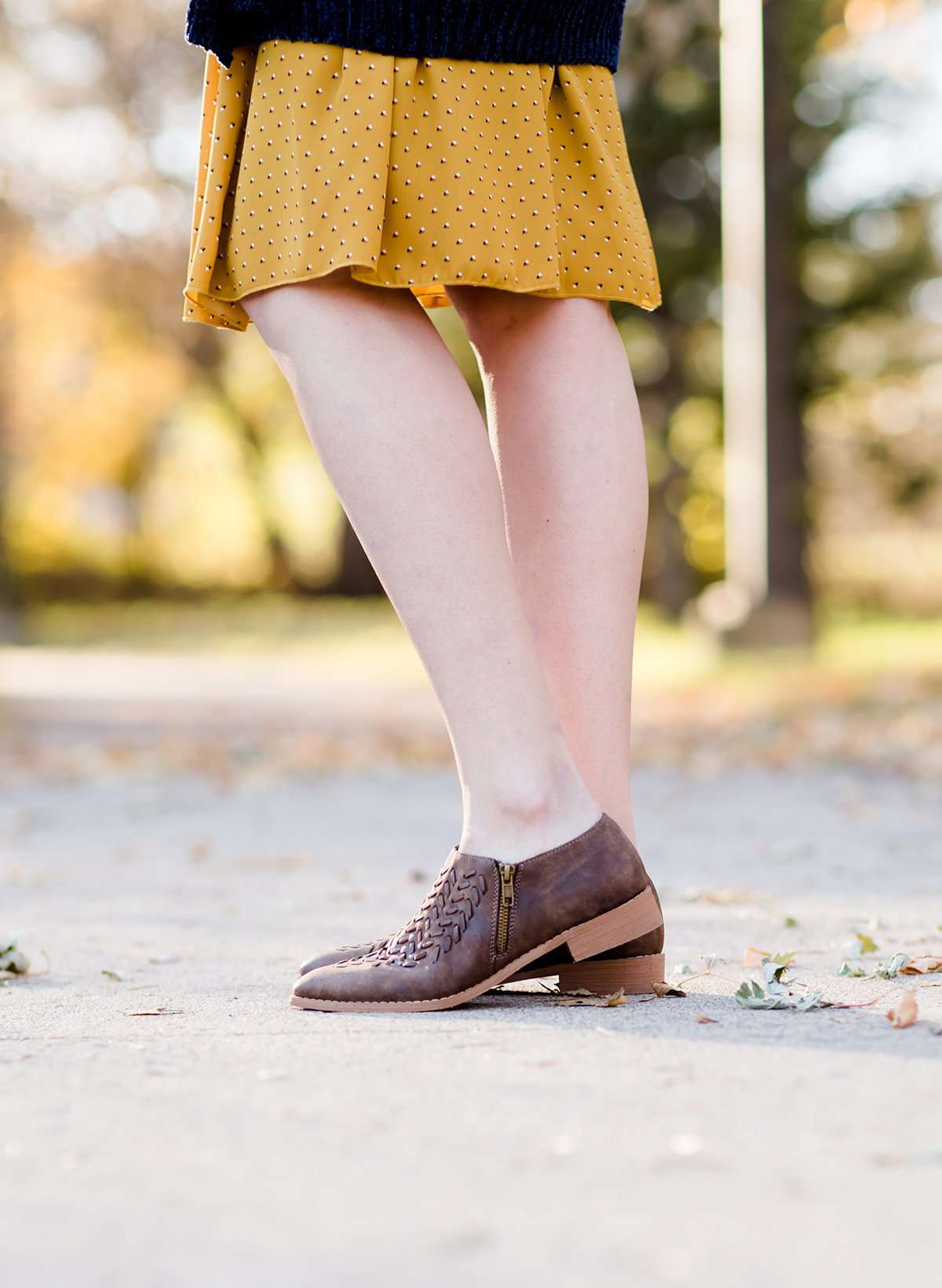 Women's braided ankle bootie in black or brown. These have a stacked heel and feature a size zipper closure.