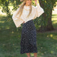 The Braylyn is an Inherit Design that is an a-line midi skirt that is black with white florals with a stretch waist and is so cute.