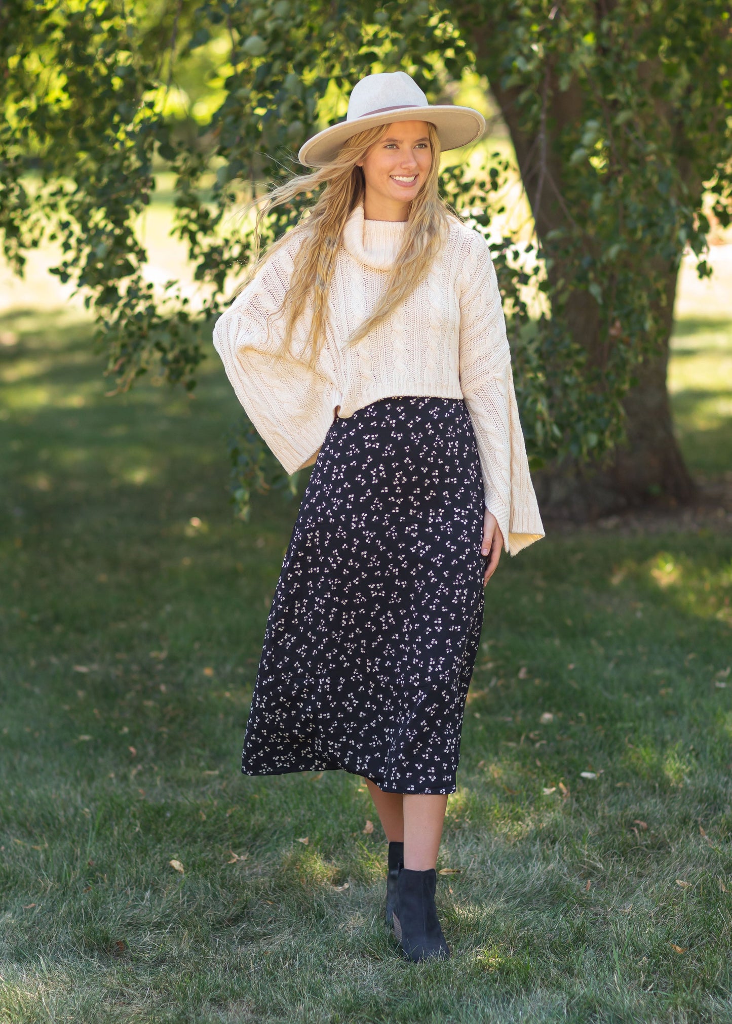 The Braylyn is an Inherit Design that is an a-line midi skirt that is black with white florals with a stretch waist and is so cute.
