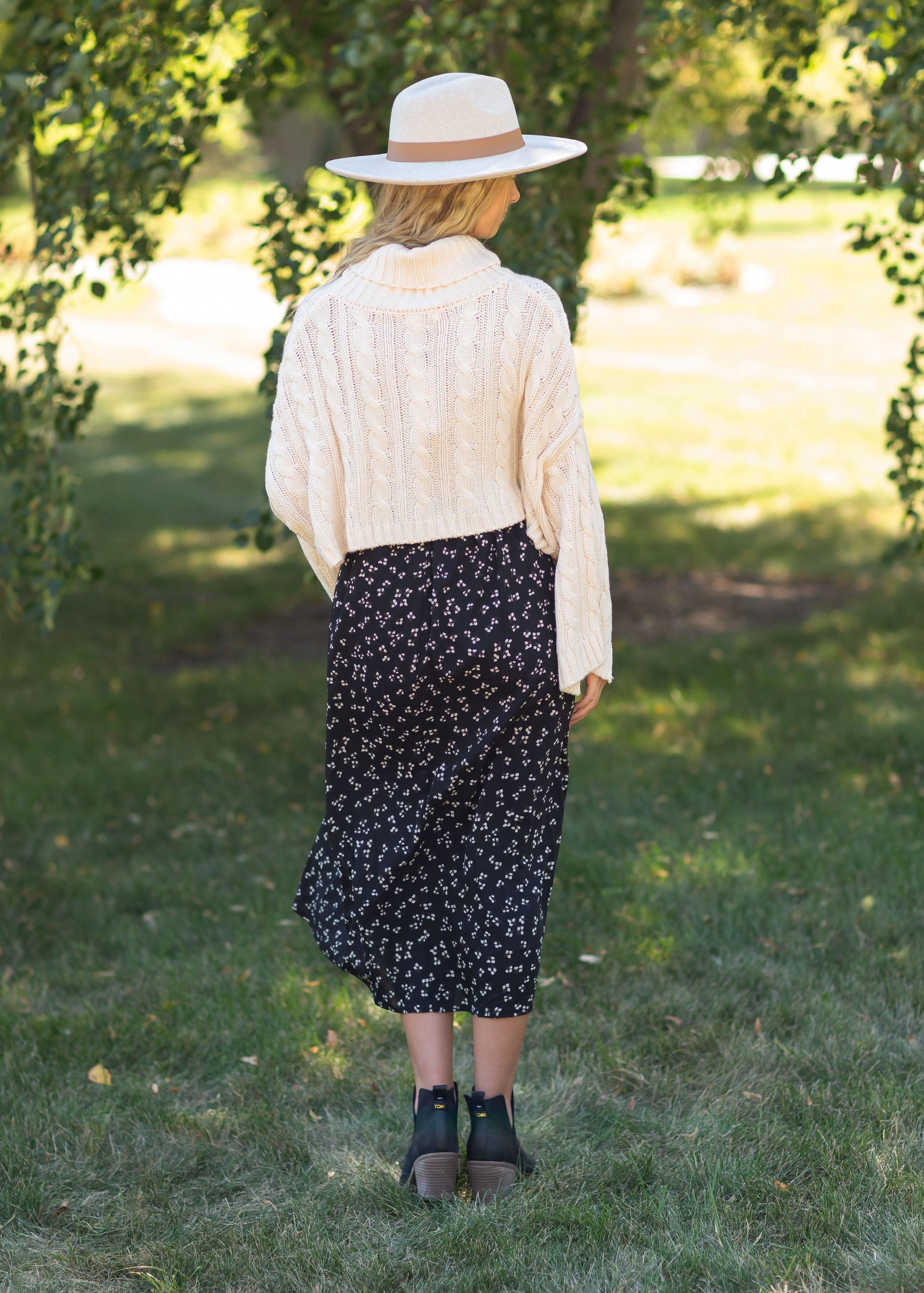 The Braylyn is an Inherit Design that is an a-line midi skirt that is black with white florals with a stretch waist and is so cute.