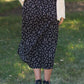 The Braylyn is an Inherit Design that is an a-line midi skirt that is black with white florals with a stretch waist and is so cute.