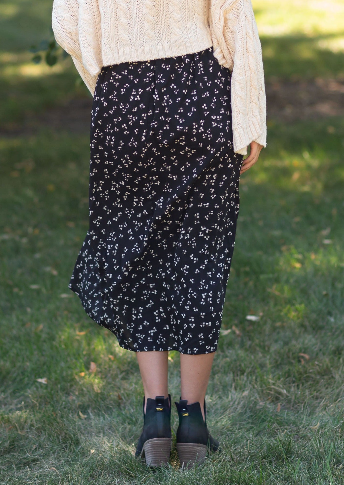 The Braylyn is an Inherit Design that is an a-line midi skirt that is black with white florals with a stretch waist and is so cute.