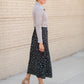 The Braylyn is an Inherit Design that is an a-line midi skirt that is black with white florals with a stretch waist and is so cute.