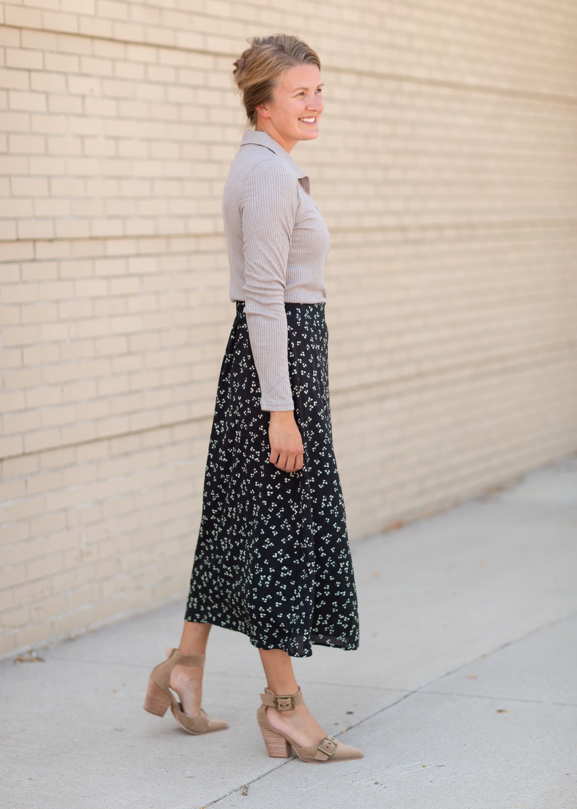 The Braylyn is an Inherit Design that is an a-line midi skirt that is black with white florals with a stretch waist and is so cute.
