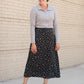 The Braylyn is an Inherit Design that is an a-line midi skirt that is black with white florals with a stretch waist and is so cute.