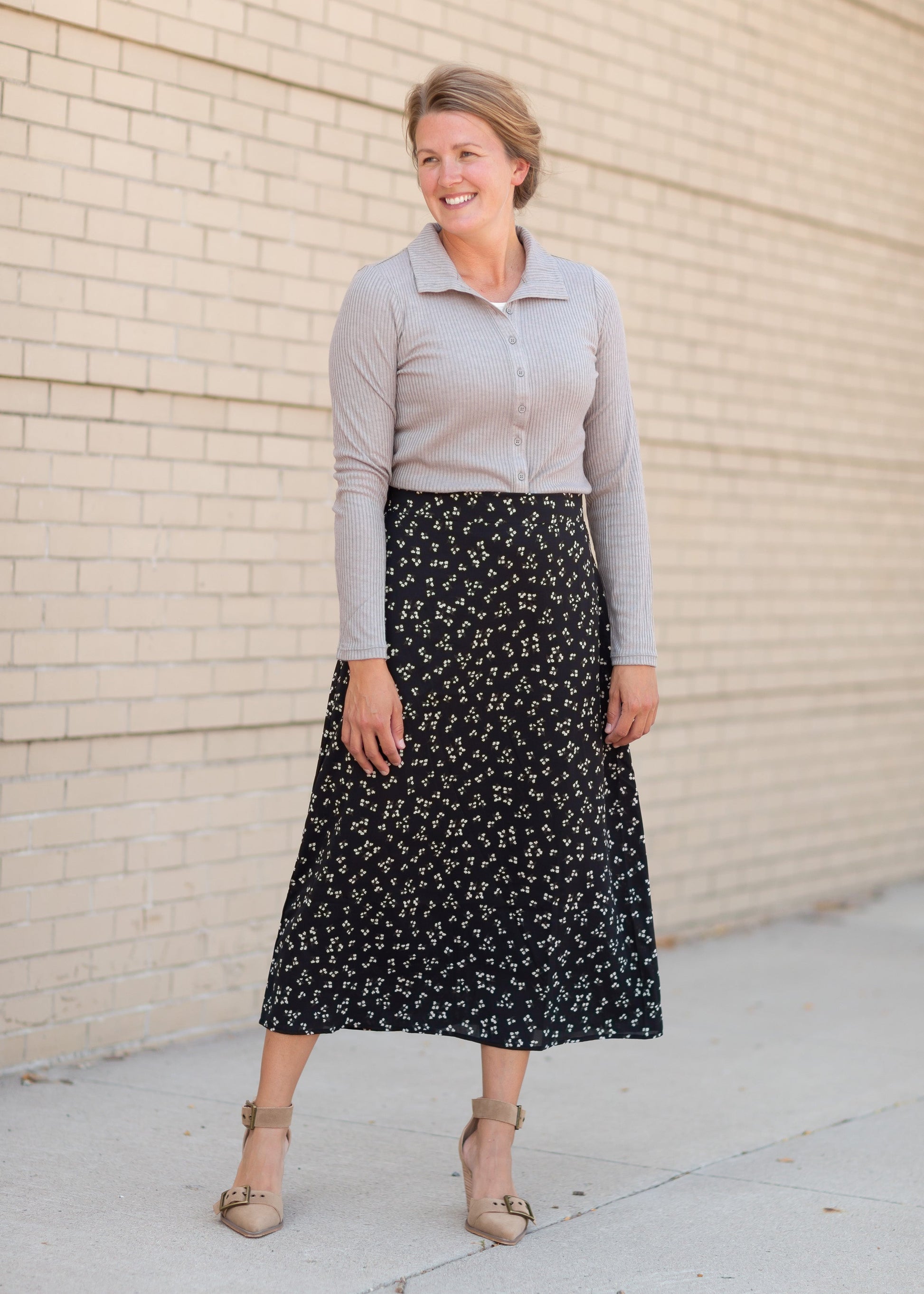 The Braylyn is an Inherit Design that is an a-line midi skirt that is black with white florals with a stretch waist and is so cute.