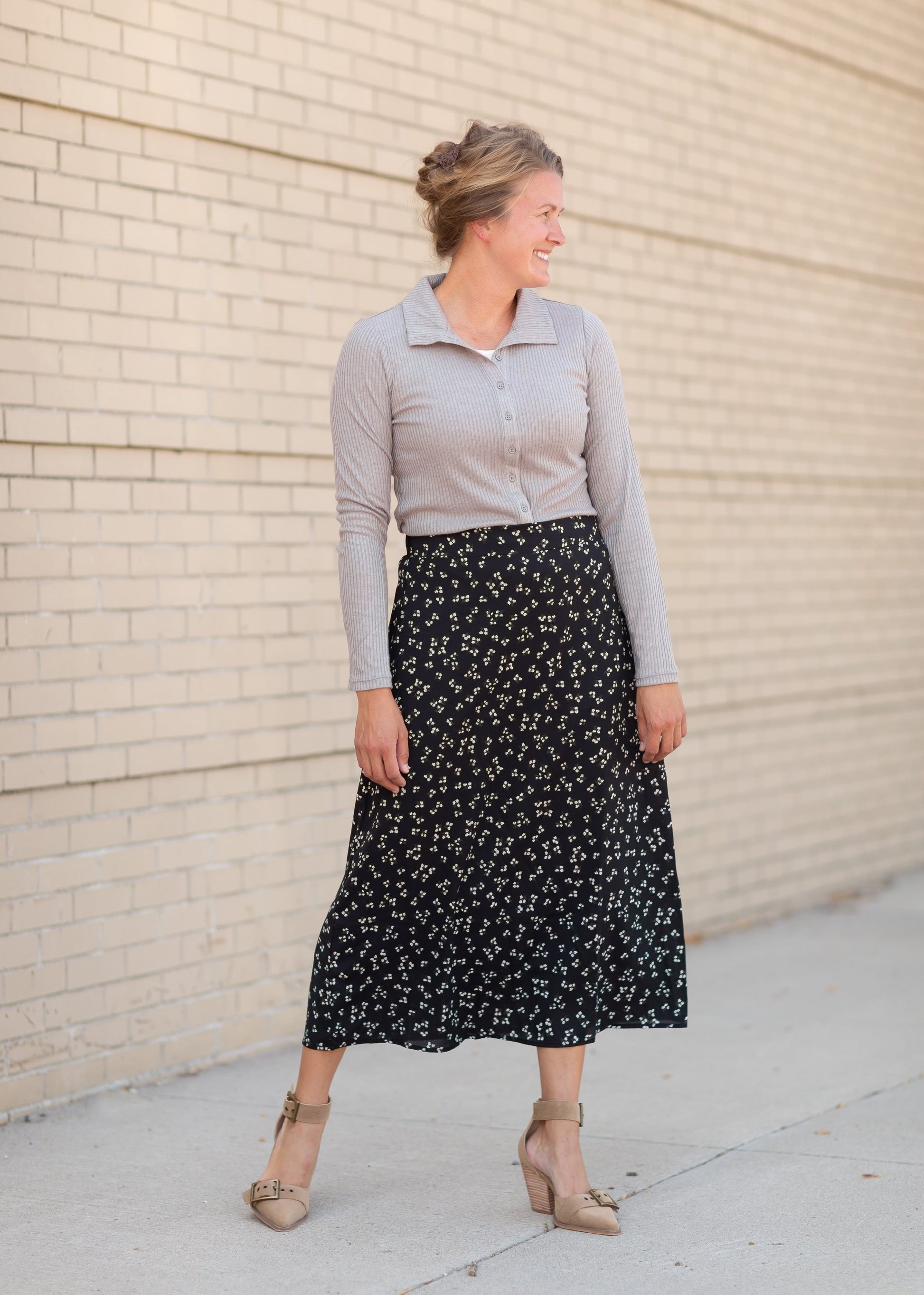 The Braylyn is an Inherit Design that is an a-line midi skirt that is black with white florals with a stretch waist and is so cute.