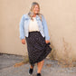 The Braylyn is an Inherit Design that is an a-line midi skirt that is black with white florals with a stretch waist and is so cute.