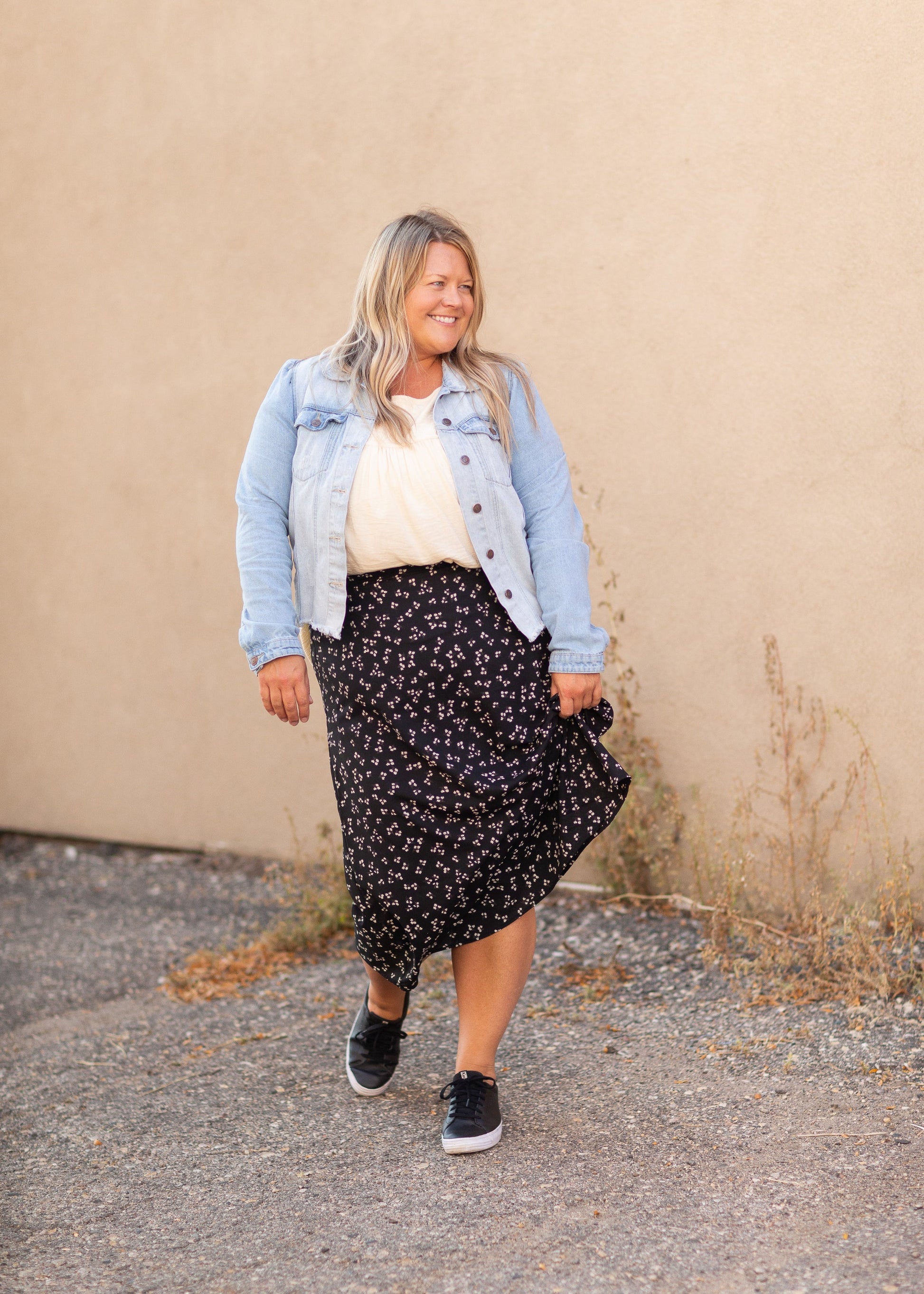The Braylyn is an Inherit Design that is an a-line midi skirt that is black with white florals with a stretch waist and is so cute.