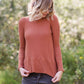 Brick in color, lightweight waffle knit long sleeve top.